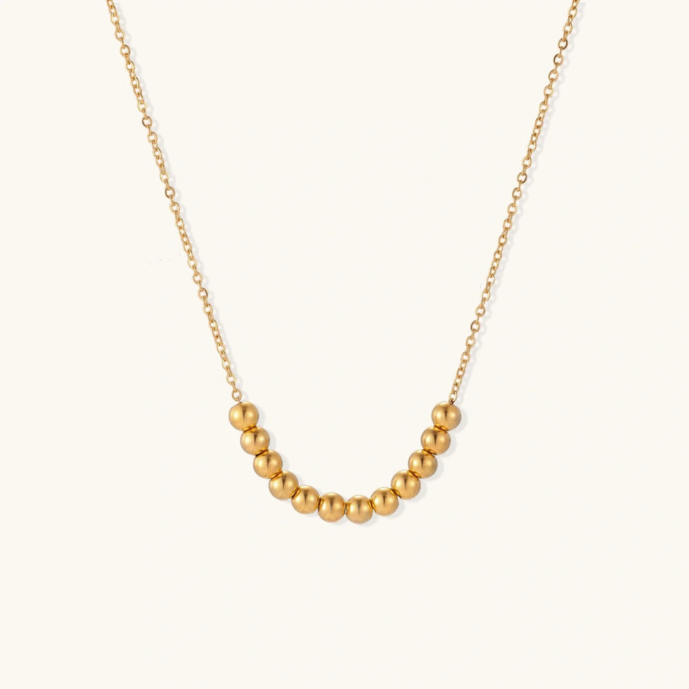 Golden Sphere Necklace showing an adjustable chain length