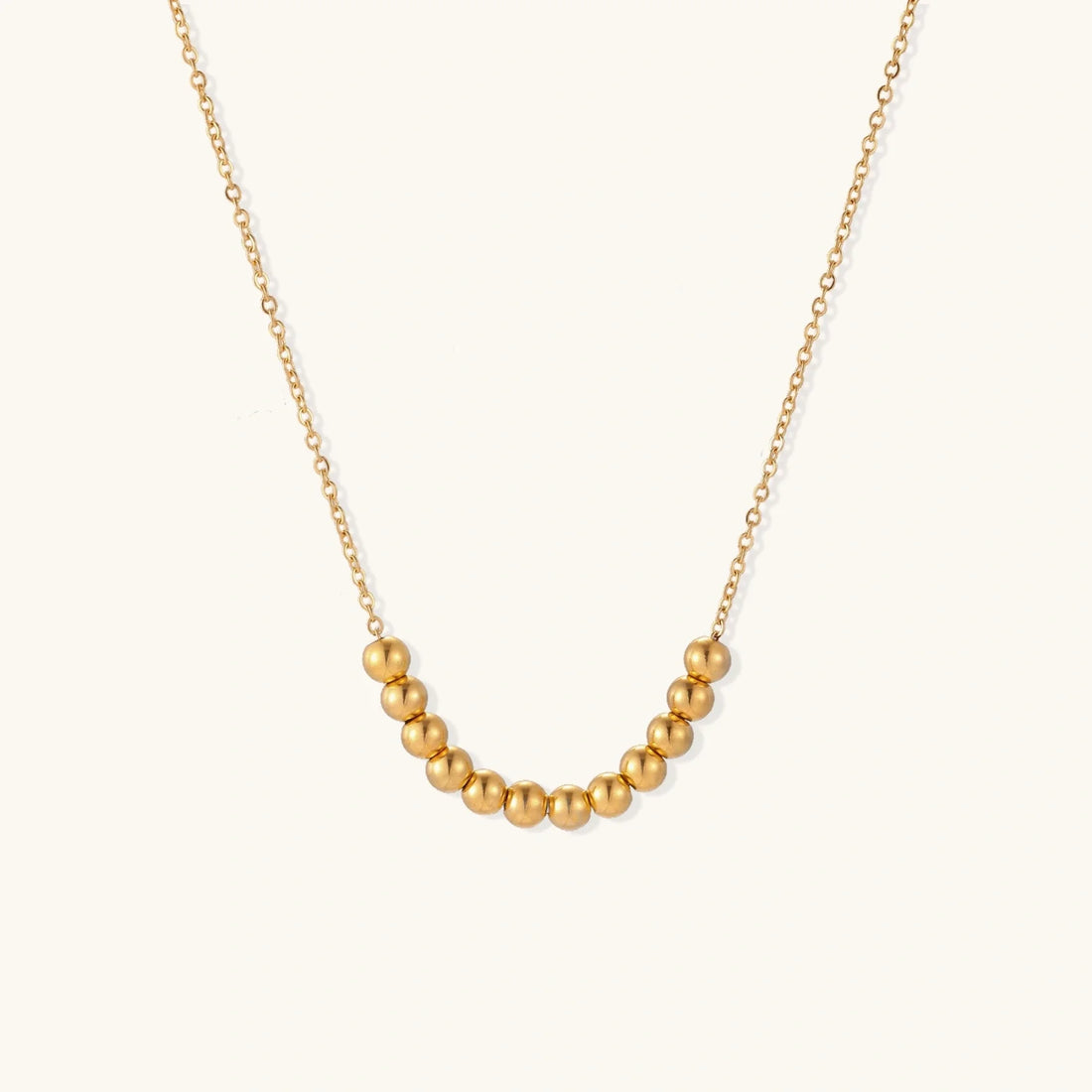 Golden Sphere Necklace showing an adjustable chain length