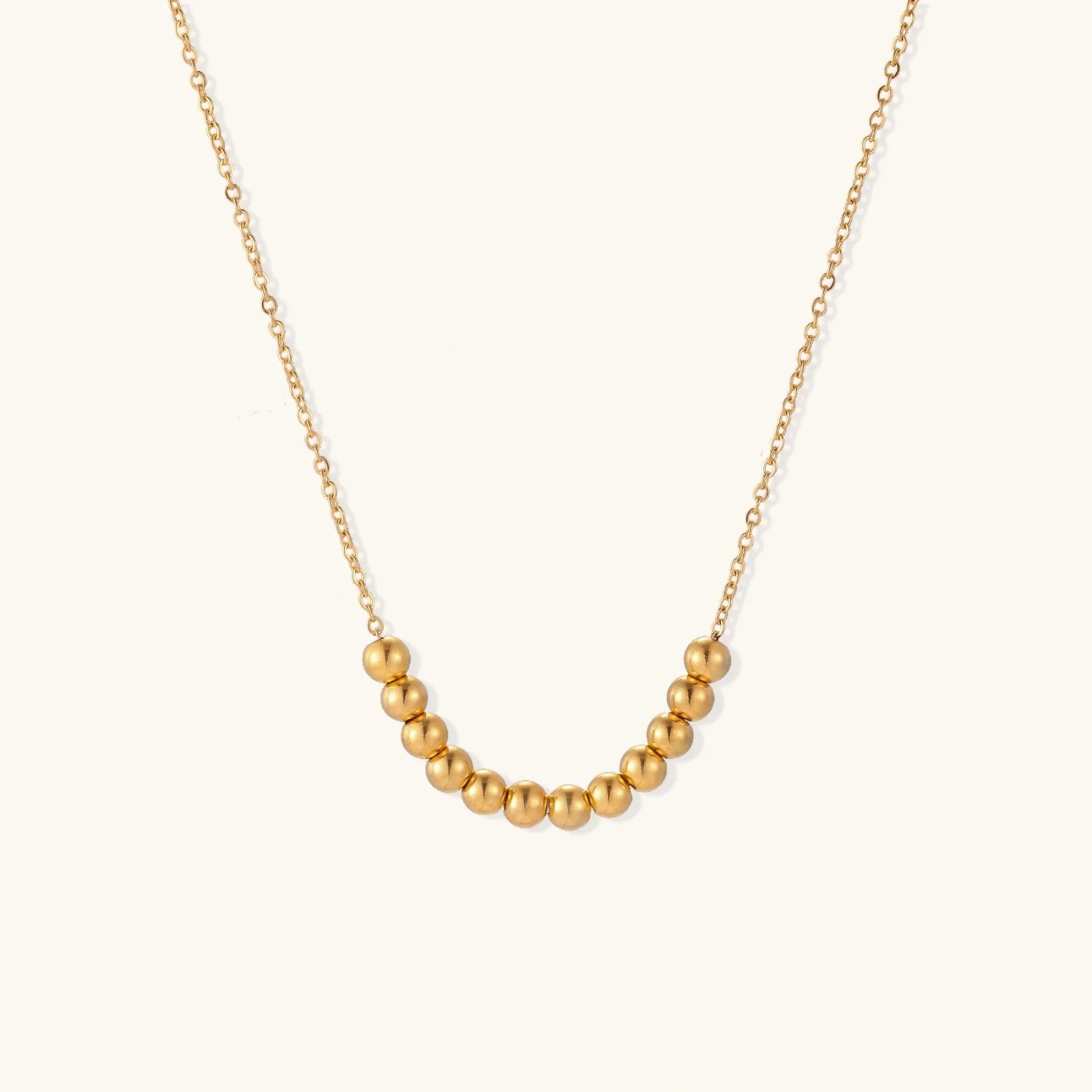 Golden Sphere Necklace showing an adjustable chain length