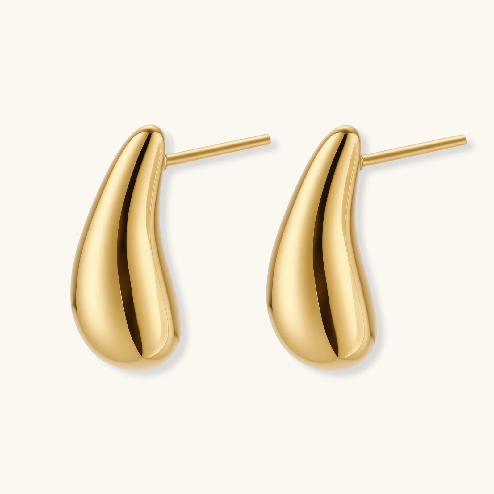 Angled view of Golden Teardrop Stud Earrings by Averuna Jewellery