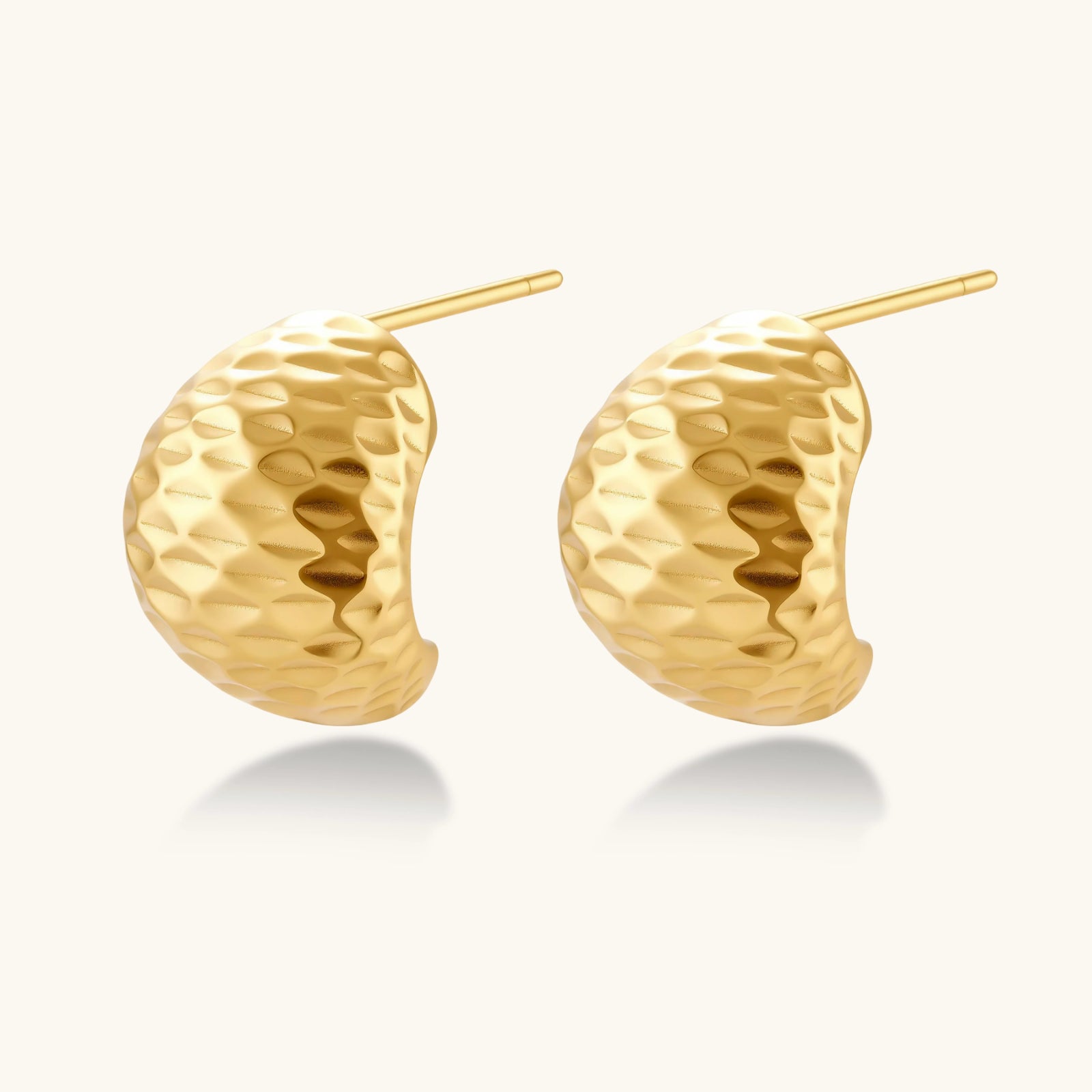 Angled view of Hammered Gold Huggie Earrings by Averuna Jewellery