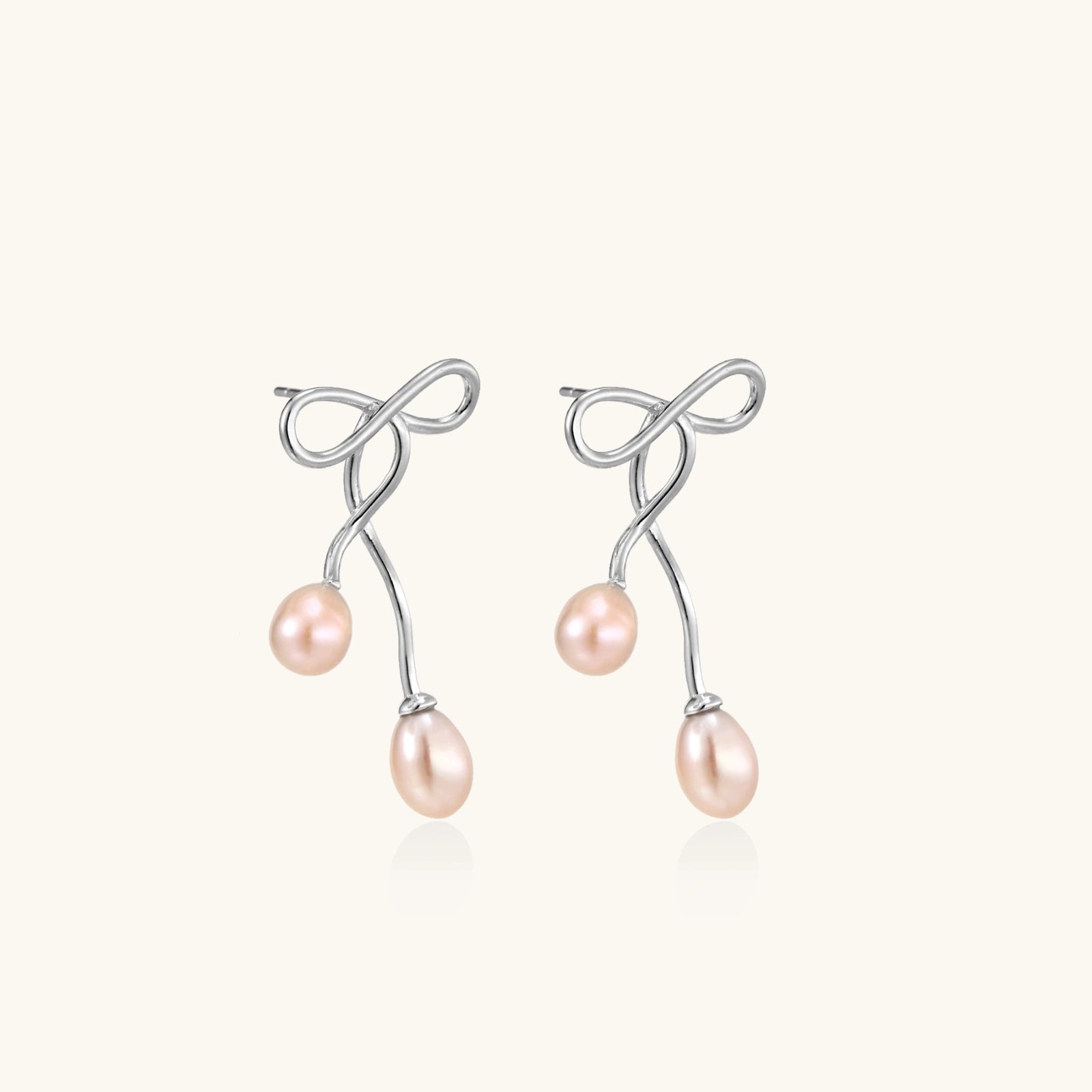 Angled view of Ethereal Pearl Drop Earrings by Averuna Jewellery