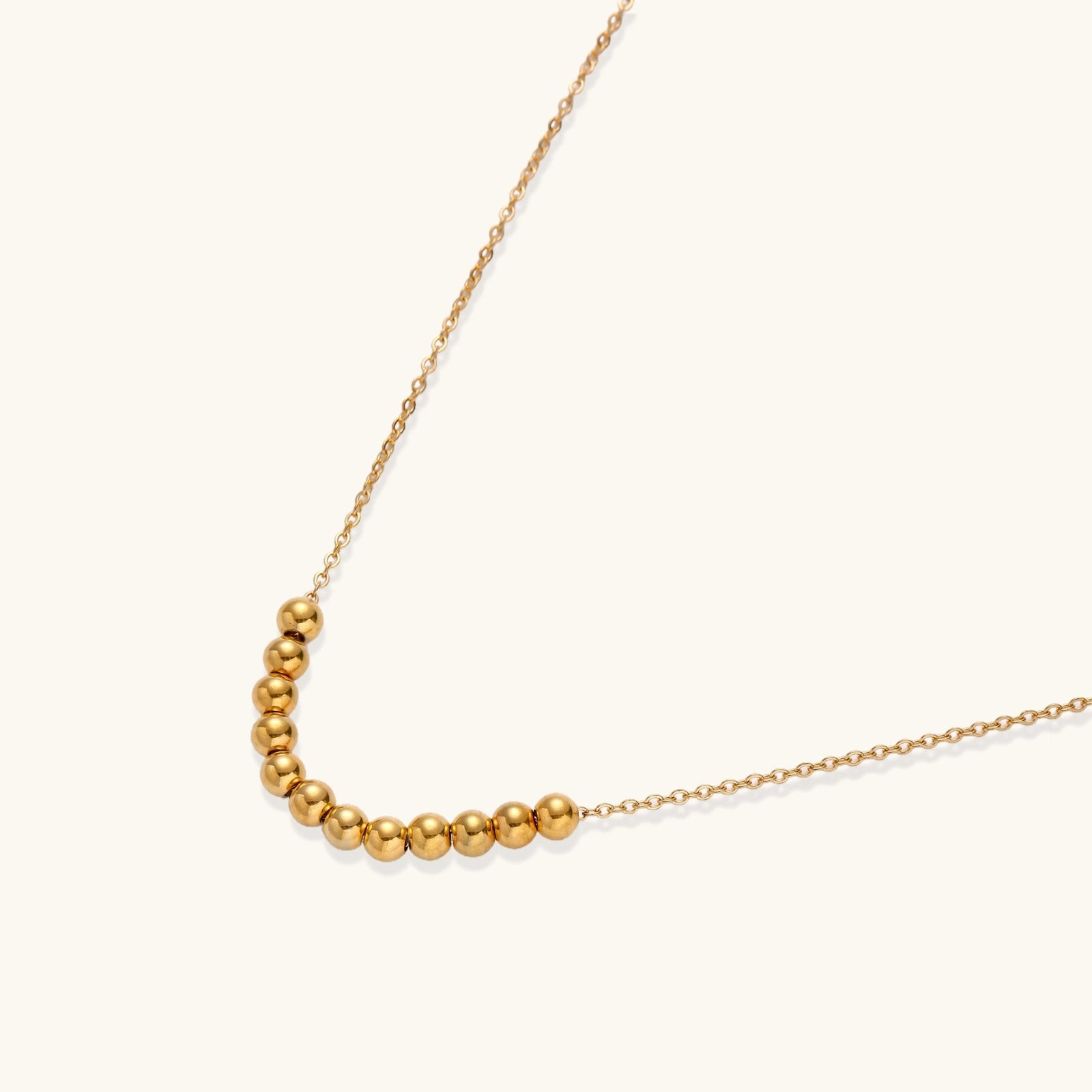 Close-up detail of Golden Sphere Necklace by Averuna Jewellery