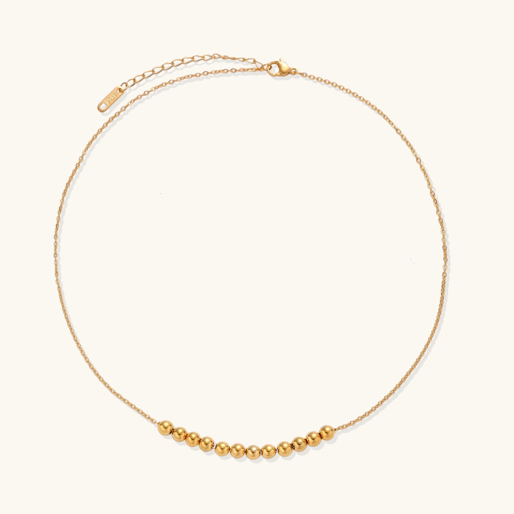 Angled view of Golden Sphere Necklace by Averuna Jewellery