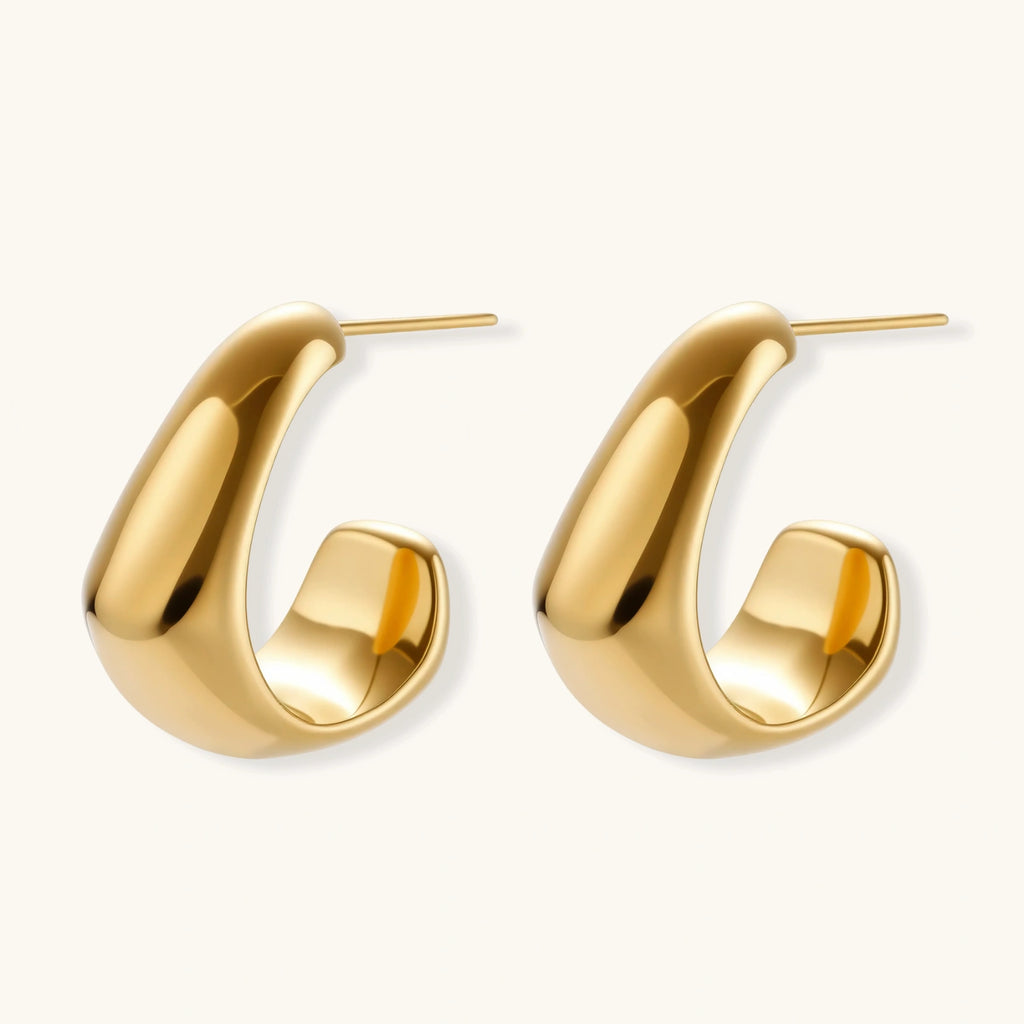 Angled view of Sculpted Curve Huggie Earrings by Averuna Jewellery