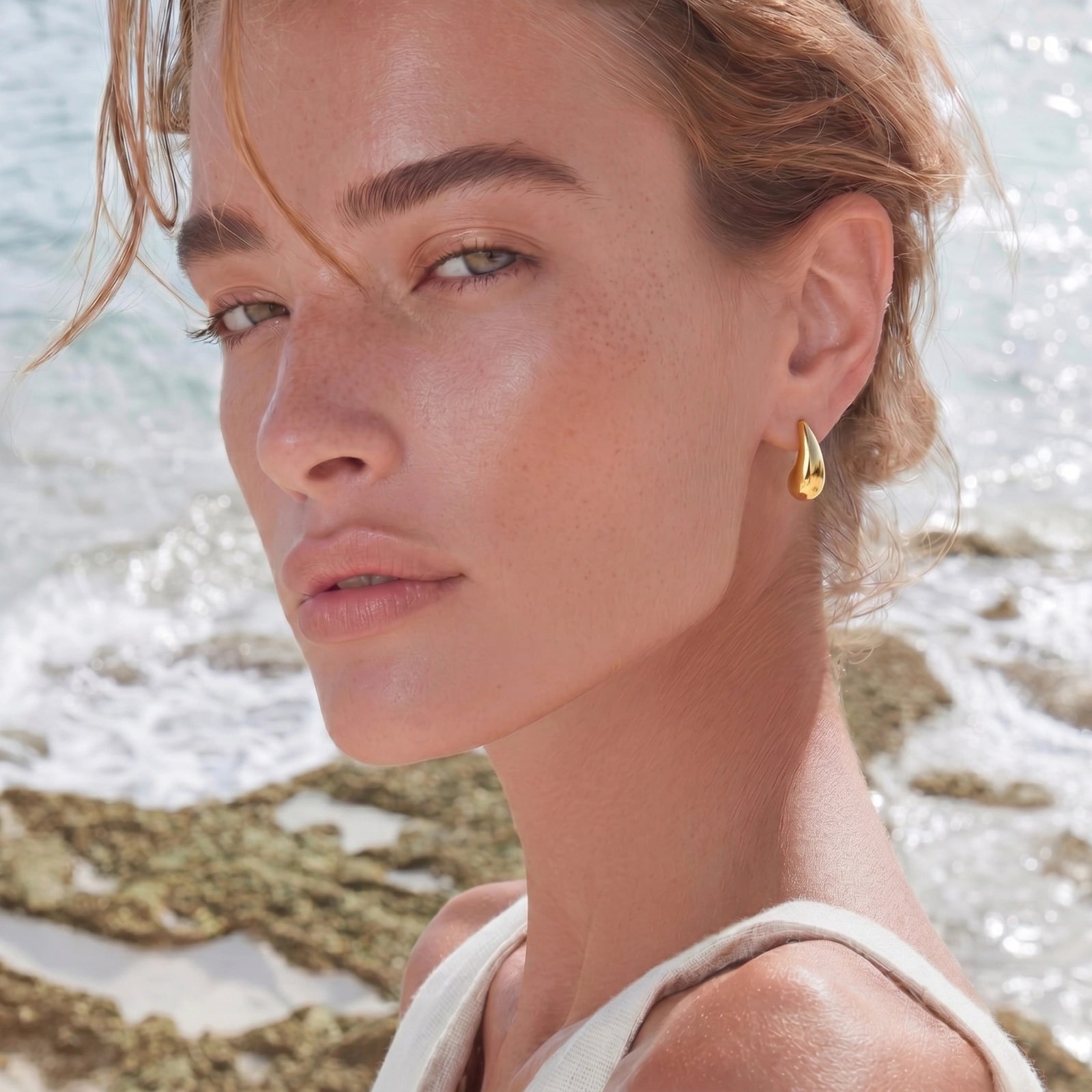 Lifestyle view of Golden Teardrop Stud Earrings by Averuna Jewellery